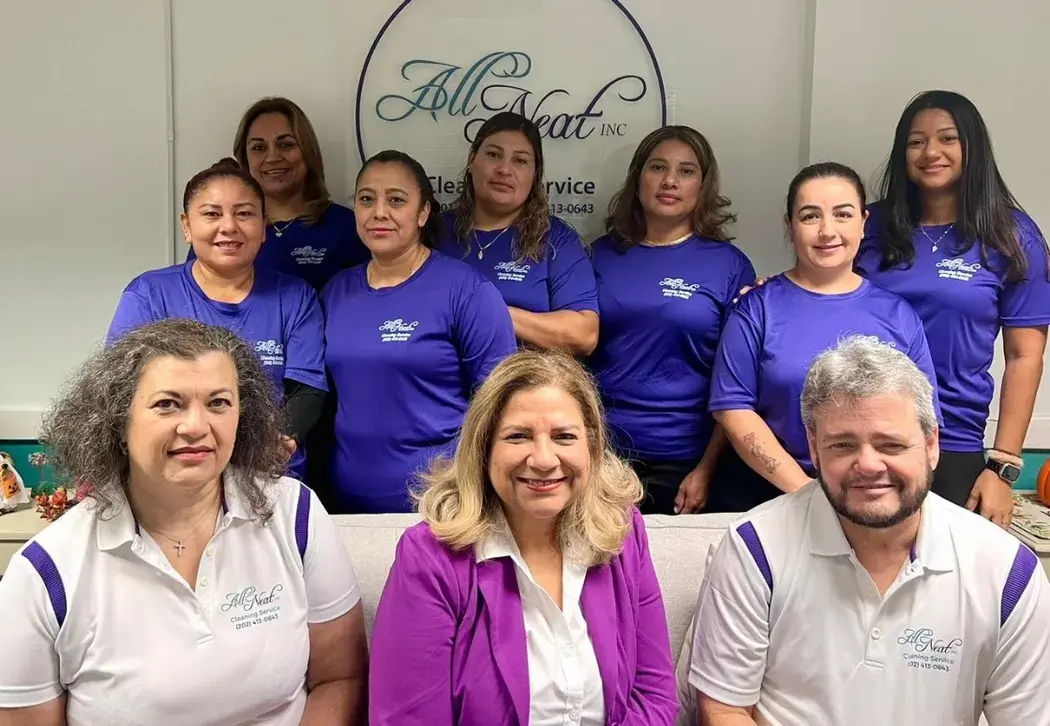 All Neat cleaning team smiling in office environment, ready to provide top-rated cleaning near me
